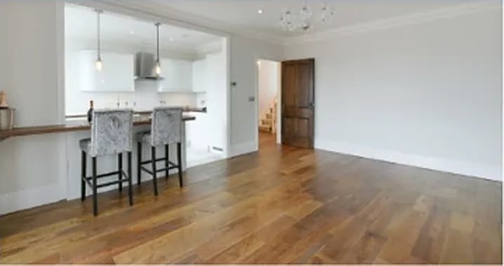 Refurbished kitchen with a breakfast bar and oak floor at Cintra Park, London SE19