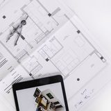 Printed house floor plan with compasses and a pencil
