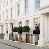 White stucco mansion block entrance in Kensington, London