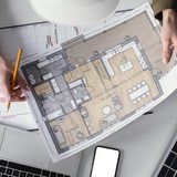 Site plan drawing for a London planning application on a desk